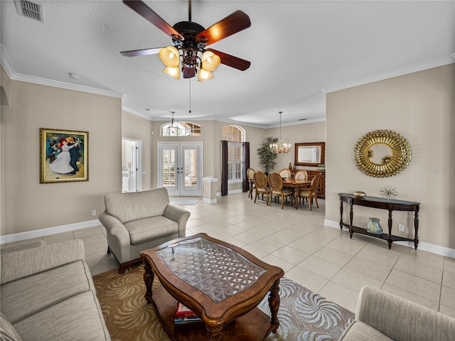 living area featuring french doors, light tile patterned flooring, visible vents, and crown molding