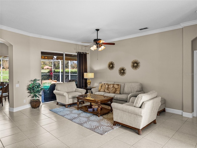 living room featuring ornamental molding, arched walkways, visible vents, and light tile patterned floors