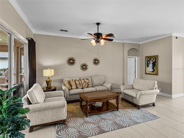 living area with visible vents, arched walkways, crown molding, and light tile patterned flooring