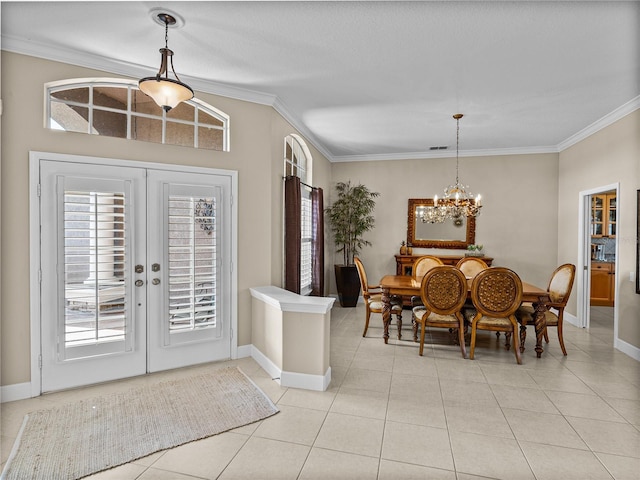 dining room featuring a chandelier, light tile patterned flooring, ornamental molding, and baseboards