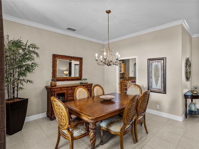 dining room with baseboards, light tile patterned flooring, visible vents, and crown molding