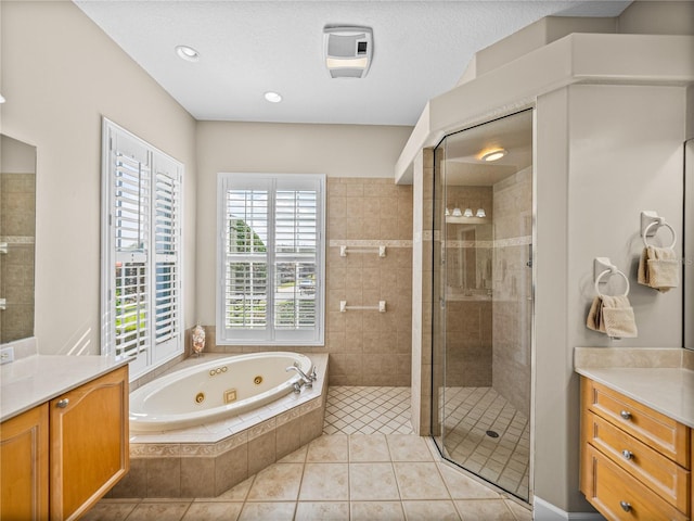 bathroom with a shower stall, a tub with jets, tile patterned flooring, and vanity