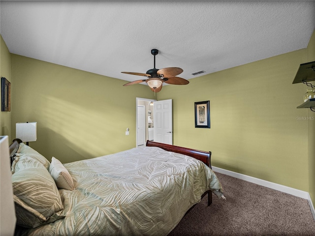 carpeted bedroom with a textured ceiling, a ceiling fan, visible vents, and baseboards