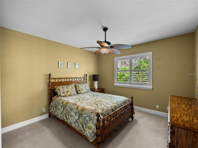 bedroom featuring a textured ceiling, ceiling fan, carpet flooring, and baseboards