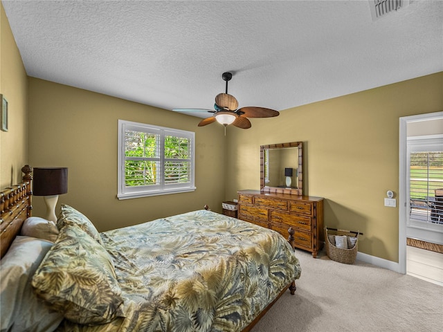 bedroom featuring baseboards, visible vents, a ceiling fan, a textured ceiling, and carpet flooring