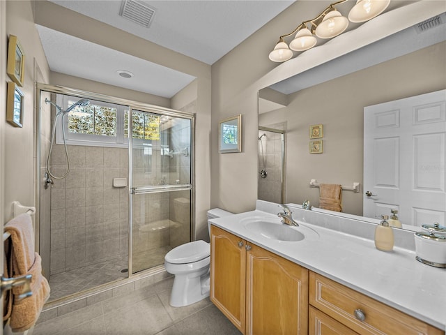 bathroom with a stall shower and visible vents