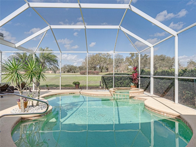 view of swimming pool featuring a lanai, a pool with connected hot tub, and a patio