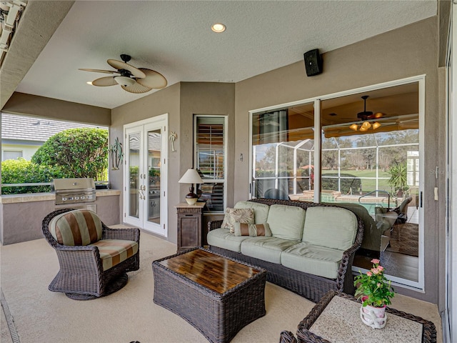 view of patio with ceiling fan, an outdoor living space, grilling area, and french doors