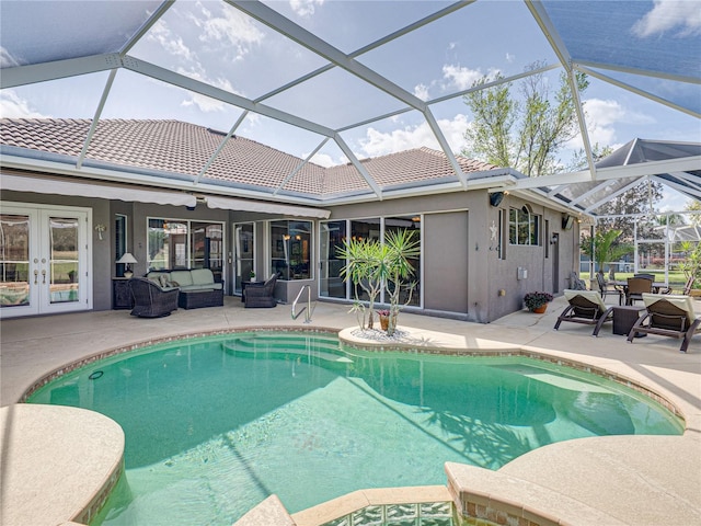 view of pool with a pool with connected hot tub, french doors, a patio, and an outdoor living space