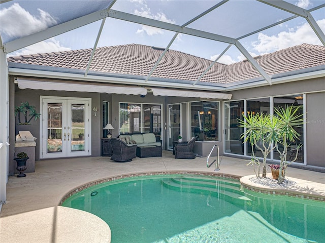 outdoor pool with a patio area, an outdoor living space, and french doors