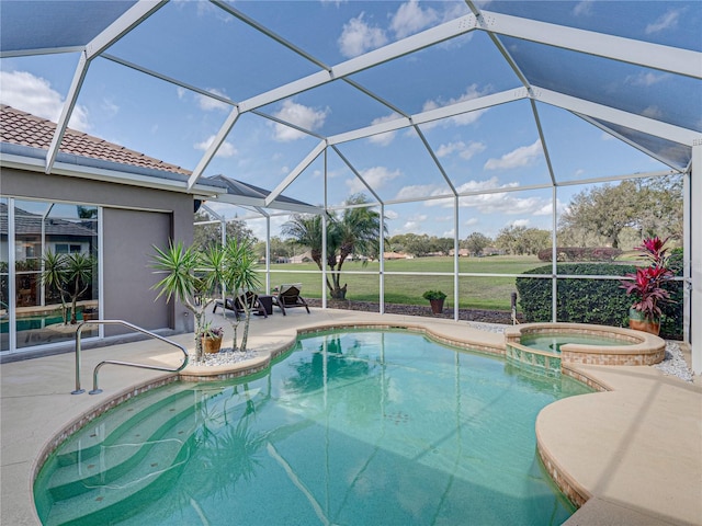 view of pool featuring glass enclosure, a patio area, and a pool with connected hot tub