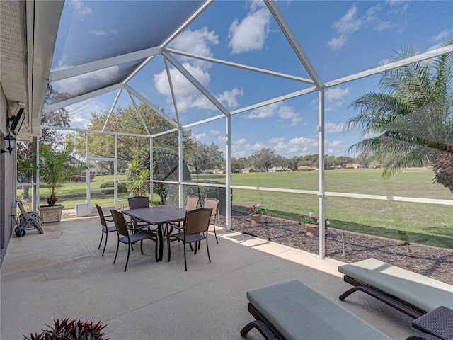 view of patio / terrace with outdoor dining space and glass enclosure