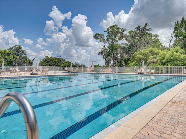 pool with fence and a patio