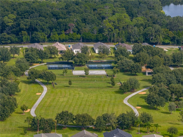 birds eye view of property featuring a water view and a view of trees