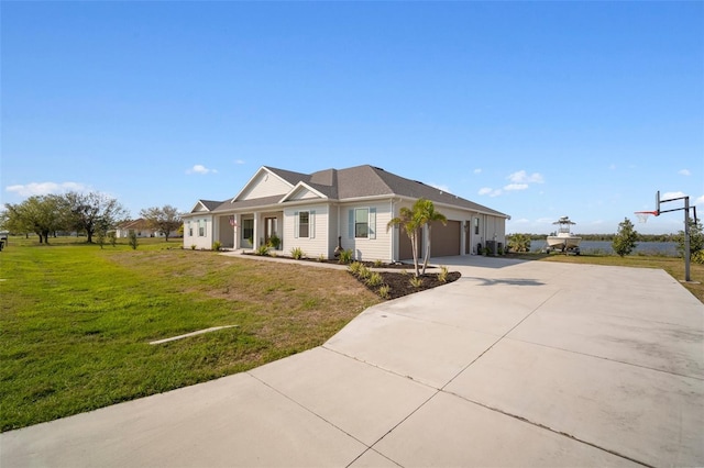 view of front facade featuring a garage, driveway, and a front lawn