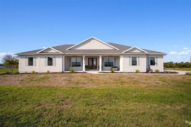 view of front of home featuring ceiling fan, french doors, and a front yard