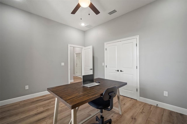 office space featuring ceiling fan, baseboards, visible vents, and light wood-style floors