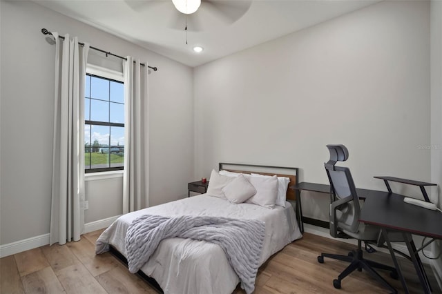 bedroom with a ceiling fan, recessed lighting, light wood-style flooring, and baseboards