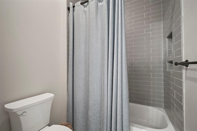 bathroom with toilet and shower / bathtub combination with curtain