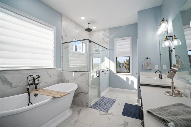 full bath featuring marble finish floor, double vanity, a sink, a shower stall, and a freestanding tub