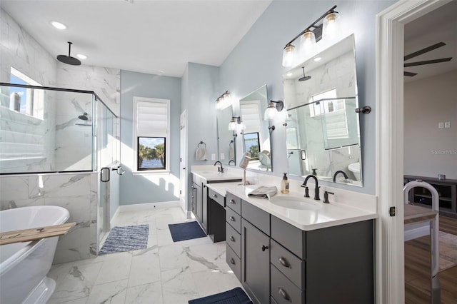 bathroom with marble finish floor, a marble finish shower, double vanity, a soaking tub, and a sink