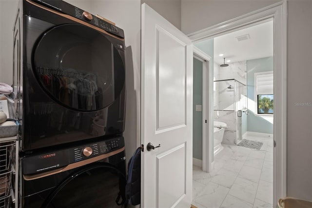 laundry room with laundry area, visible vents, baseboards, marble finish floor, and stacked washing maching and dryer