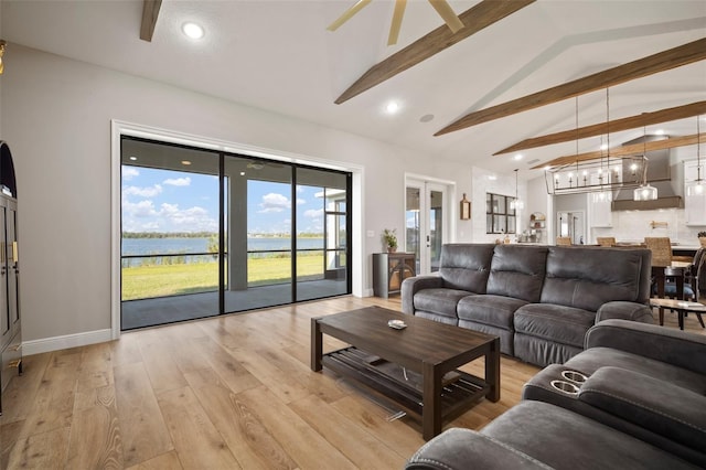 living area with french doors, light wood-style flooring, beamed ceiling, baseboards, and ceiling fan with notable chandelier