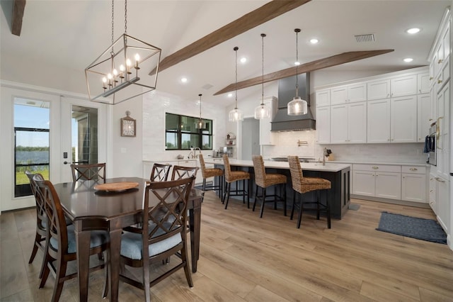 dining area with lofted ceiling with beams, light wood finished floors, visible vents, and recessed lighting