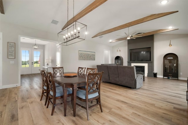 dining room featuring vaulted ceiling with beams, light wood-style flooring, visible vents, baseboards, and french doors