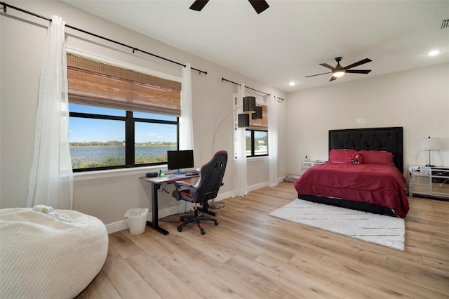 bedroom featuring visible vents, baseboards, wood finished floors, and recessed lighting