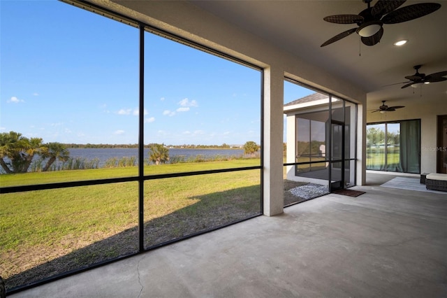 unfurnished sunroom with a water view