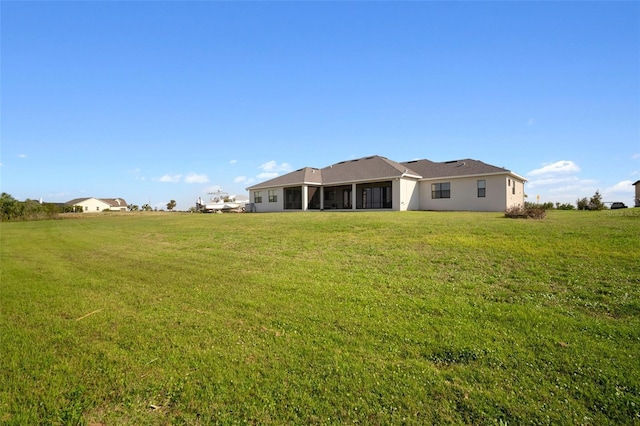 rear view of property with a lawn