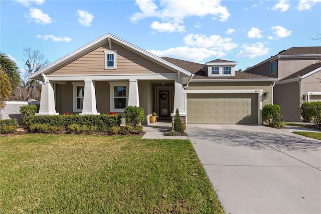 view of front of property with concrete driveway, an attached garage, covered porch, a front yard, and stucco siding