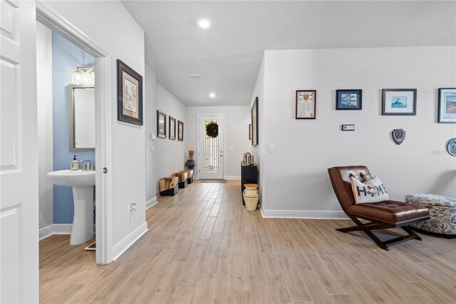 interior space with recessed lighting, baseboards, and light wood finished floors