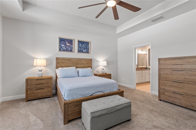 bedroom featuring baseboards, visible vents, a raised ceiling, and carpet flooring