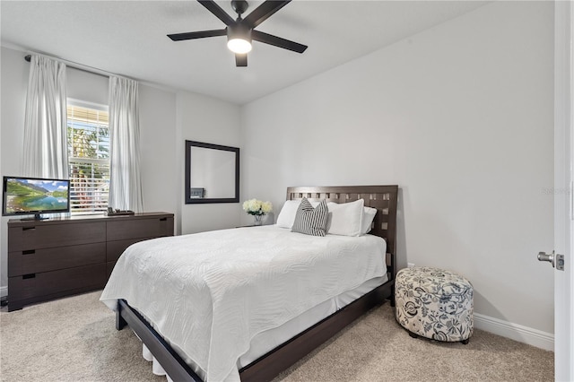 carpeted bedroom featuring ceiling fan and baseboards