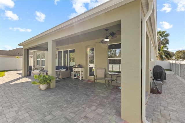 view of patio / terrace with a ceiling fan, a fenced backyard, outdoor lounge area, and grilling area