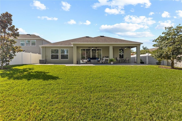 back of property featuring a lawn, an outdoor hangout area, a ceiling fan, a patio area, and fence