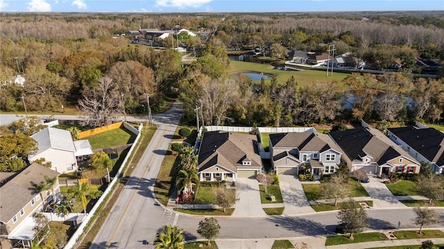 birds eye view of property with a water view, a residential view, and a view of trees