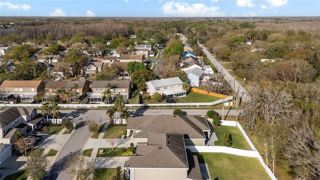 aerial view featuring a forest view and a residential view