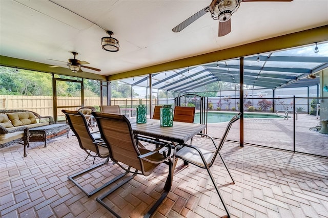 sunroom / solarium featuring ceiling fan