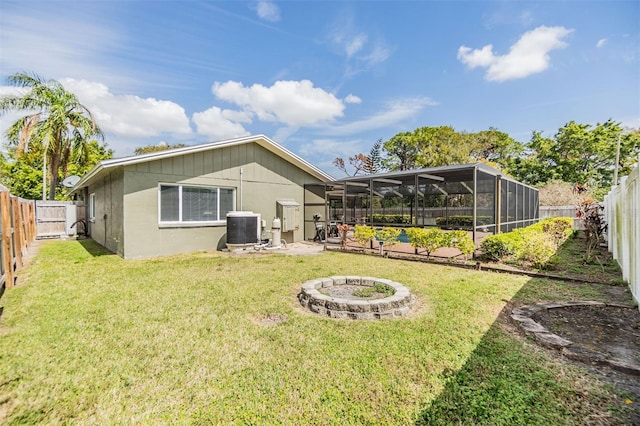 back of property featuring glass enclosure, a fenced backyard, central air condition unit, a pool, and a yard