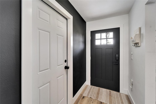 4118 Ramona Dr, Spring Hill, FL 34606 - foyer entrance with baseboards and light wood-style floors