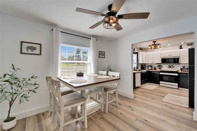 4118 Ramona Dr, Spring Hill, FL 34606 - dining area featuring a ceiling fan, light wood-type flooring, and a textured ceiling