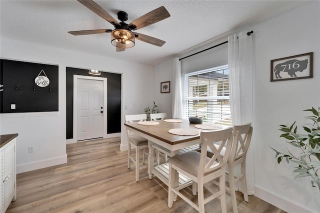 4118 Ramona Dr, Spring Hill, FL 34606 - dining room with ceiling fan, light wood-style floors, and a textured ceiling