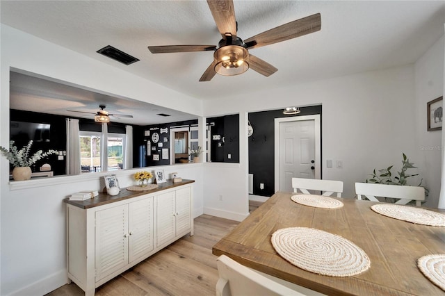 4118 Ramona Dr, Spring Hill, FL 34606 - kitchen featuring ceiling fan, light wood-style floors, white cabinetry, and a peninsula