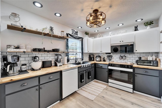 4118 Ramona Dr, Spring Hill, FL 34606 - kitchen featuring white range oven, wood counters, open shelves, dishwashing machine, and recessed lighting