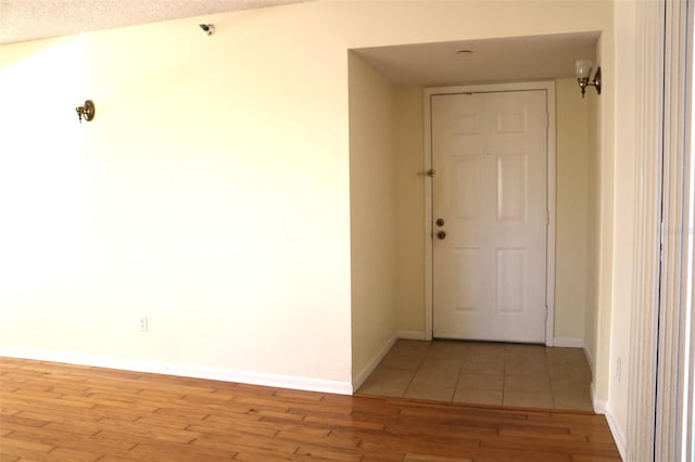 hallway with baseboards and light wood finished floors