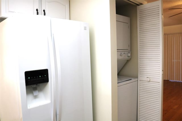 laundry room featuring stacked washer and clothes dryer and laundry area