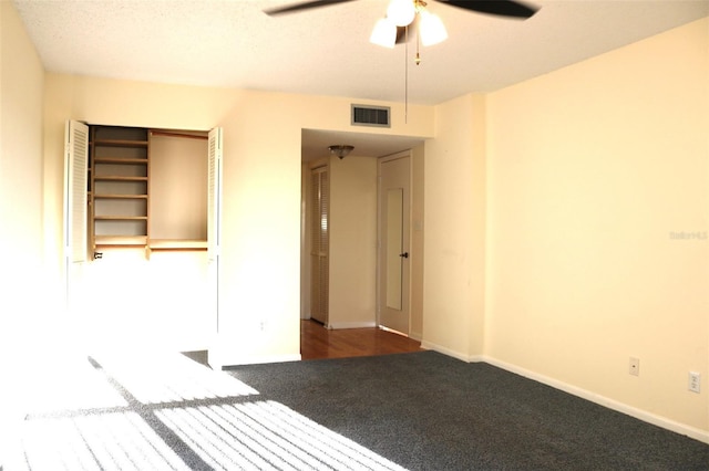 unfurnished bedroom featuring visible vents, baseboards, carpet, and ceiling fan